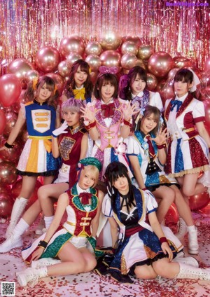 A group of young women dressed in colorful outfits posing for a picture.