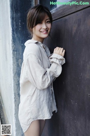 A woman in a white dress posing for a picture.