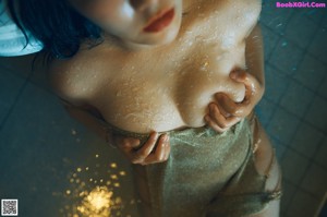 A naked woman sitting on a toilet in a bathroom.