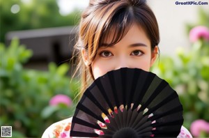 a woman in a yellow and blue kimono holding a book