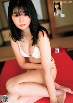 A woman in a red bathing suit is posing for a picture.