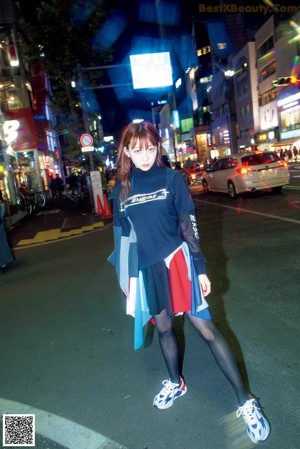A woman in a sweater is posing for a magazine cover.