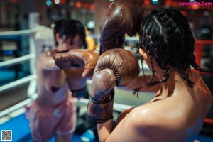 A woman in a boxing ring with boxing gloves on.