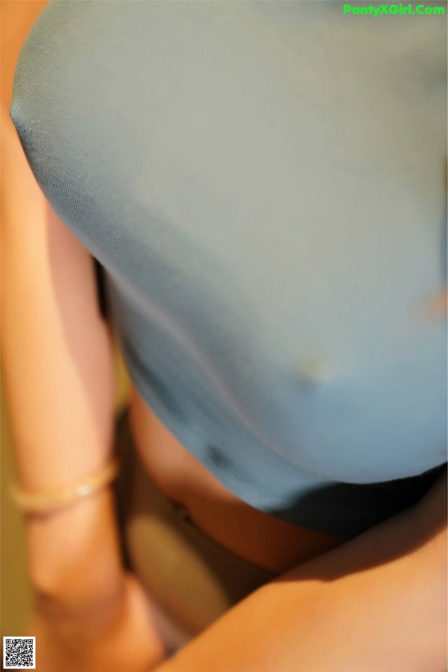 A close up of a woman's butt with a blue shirt on.