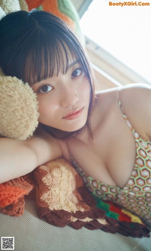 A woman in a pink shirt is posing for a picture.