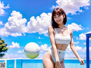 A woman in a pink bikini posing for a picture.