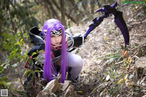 A woman with purple hair is posing for a picture.