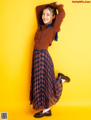 A magazine with a picture of a woman in a sweater.