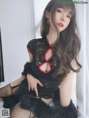 A woman in fishnet stockings is sitting on a chair.