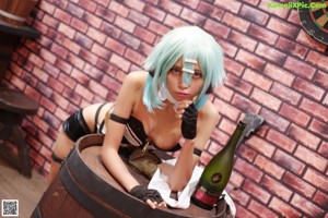 A naked woman with blue hair is posing for the camera.