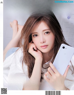 A magazine page with a picture of a woman in a white shirt.