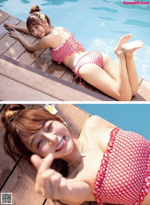 A woman sitting on top of a bed in a black top and shorts.